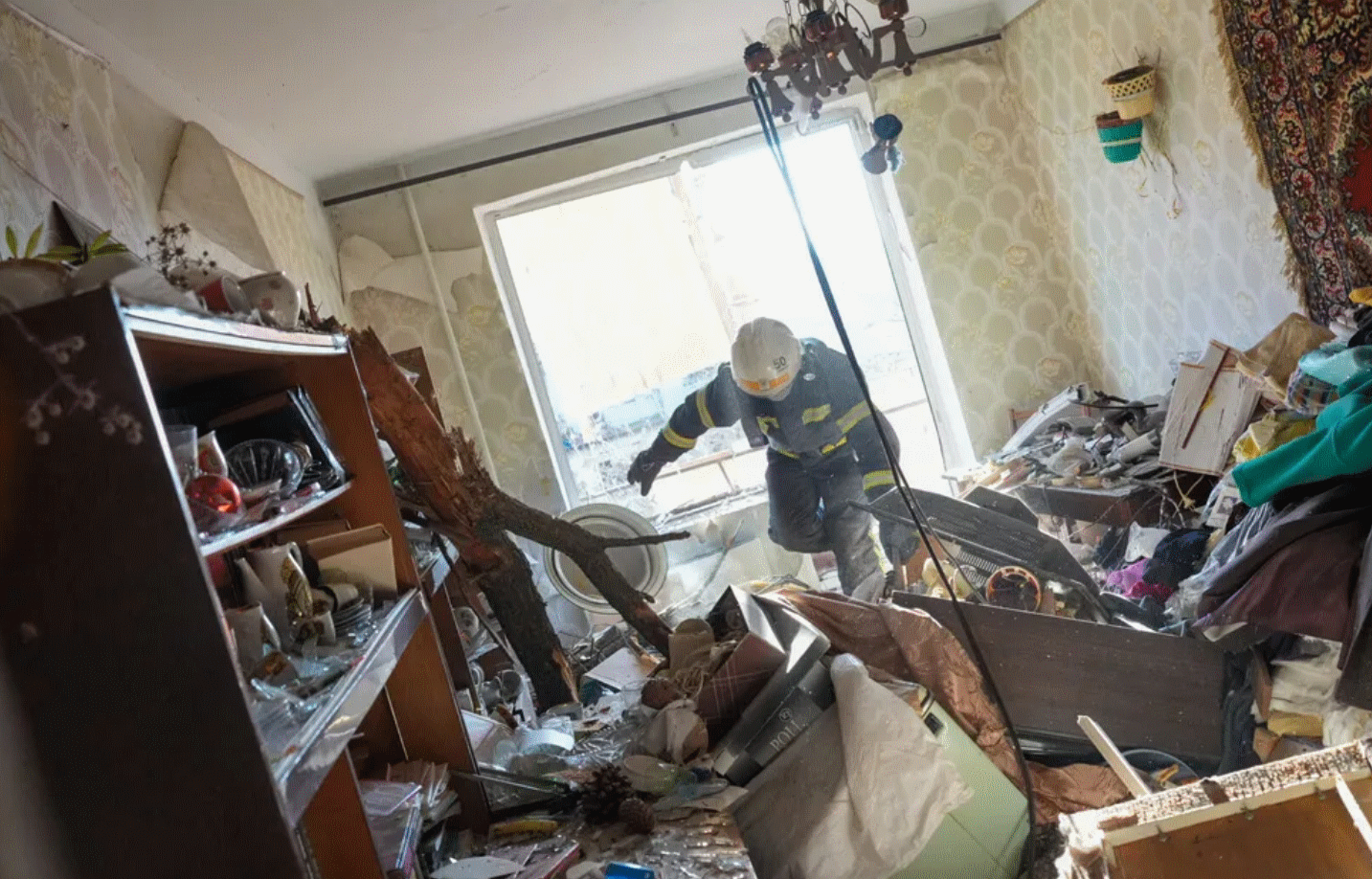 A Ukrainian firefighter clearing a residential building struck by Russian fire. Retrieved from the Huffington Post.